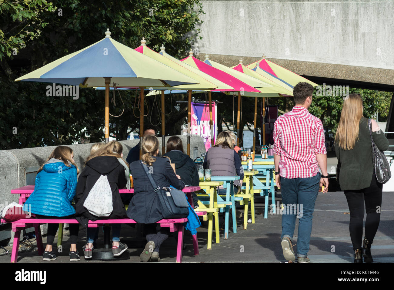 Garden umbrellas and tables outside the Wahaca restaurant and cafe at the South Bank Centre, London, UK Stock Photo