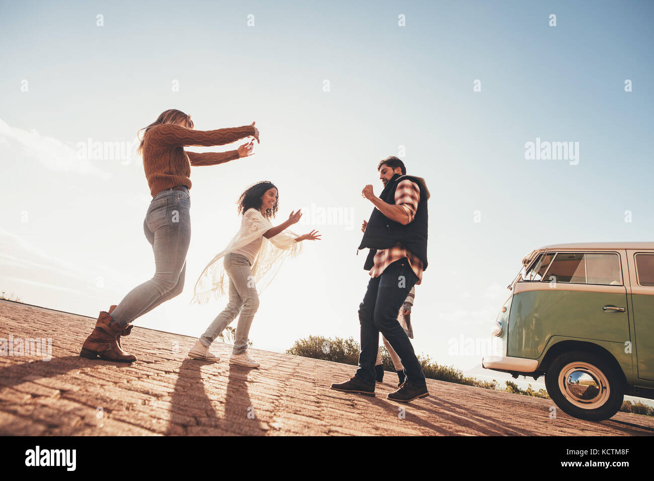 Group of friends having fun together on road trip. Man with female ...