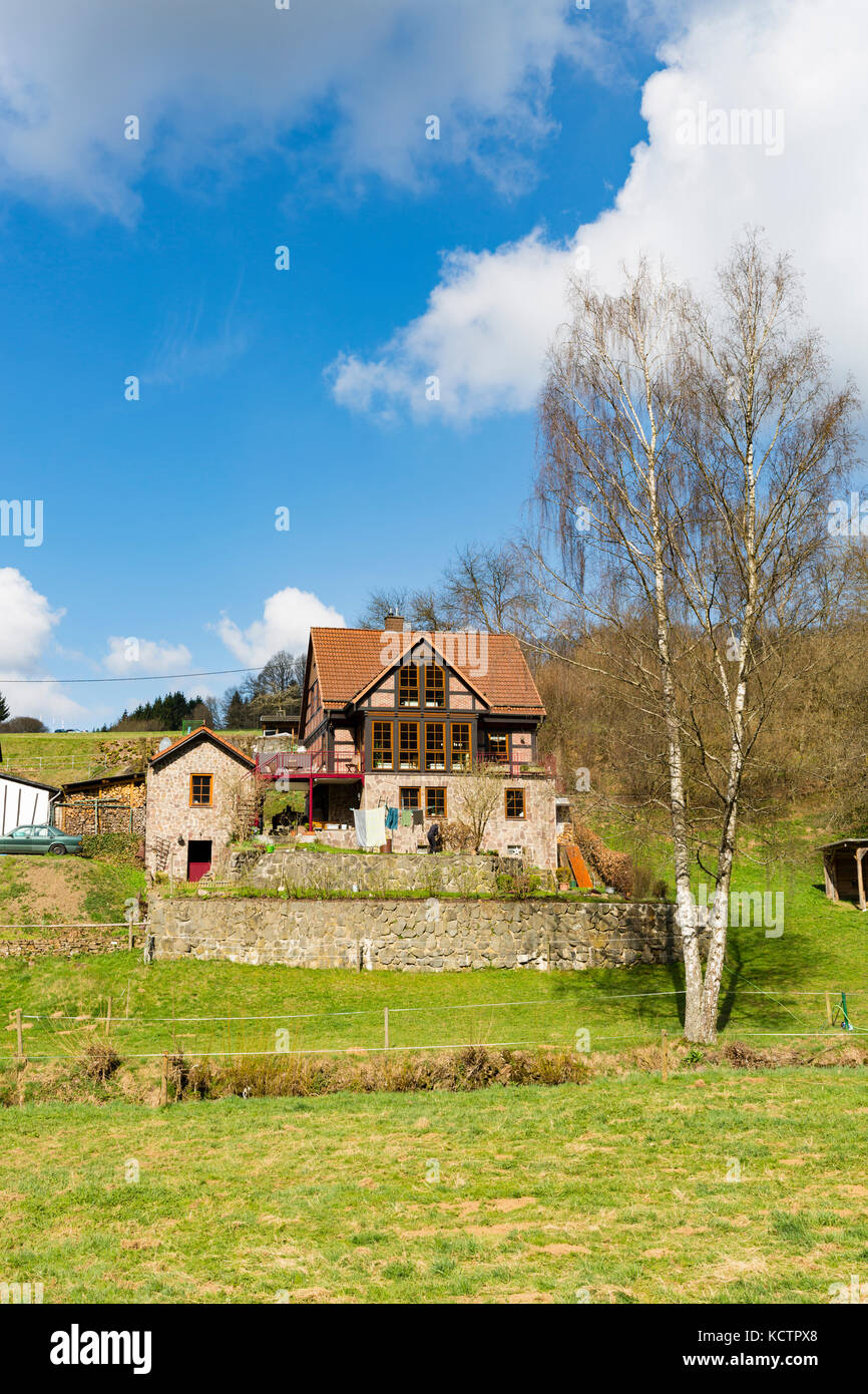 A beautiful house in the Eifel hills in Daun, Germany in spring. Stock Photo