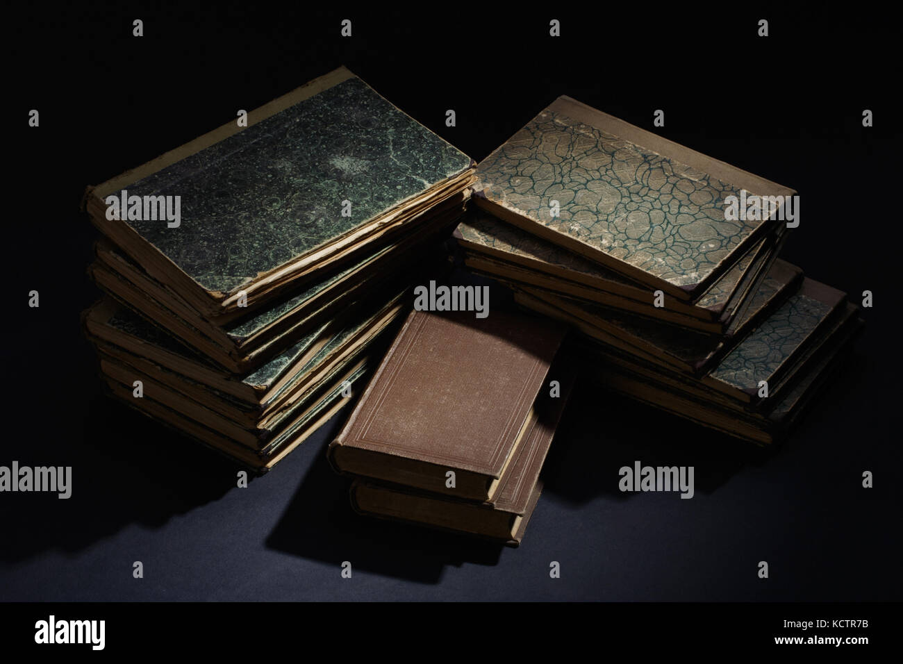 old books, papers, ink pen and inkpot on black background Stock Photo