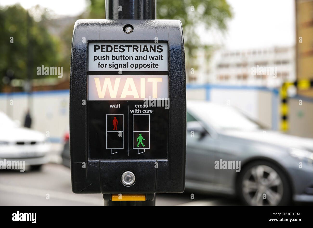 A pedestrian crossing point in London with cars in the background Stock Photo