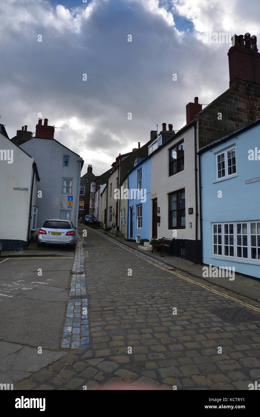 Street scene with houses and cobbled road, Staithes, North Yorkshire UK Stock Photo