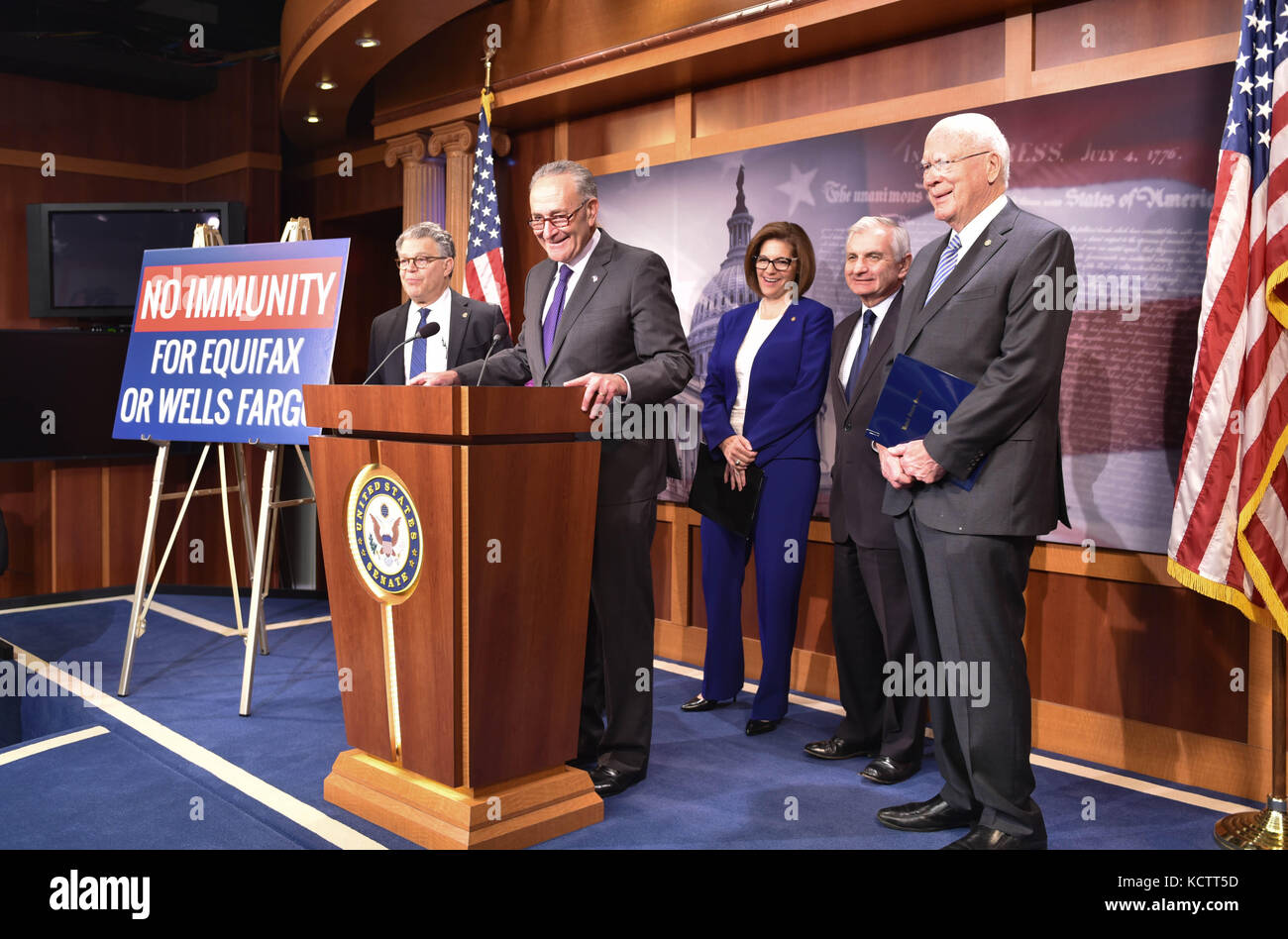 U.S Senate Minority Leader Chuck Schumer of New York, alongside fellow Democrats, holds a press conference in the wake of a massive data breach at Equifax and a scandal at Wells Fargo on Capitol Hill September 27, 2017 in Washington, DC. Standing behind Schumer is Senator Al Franken, left, Senator Catherine Cortez Masto, center, Senator Jack Reed and Senator Patrick Leahy, right. Stock Photo