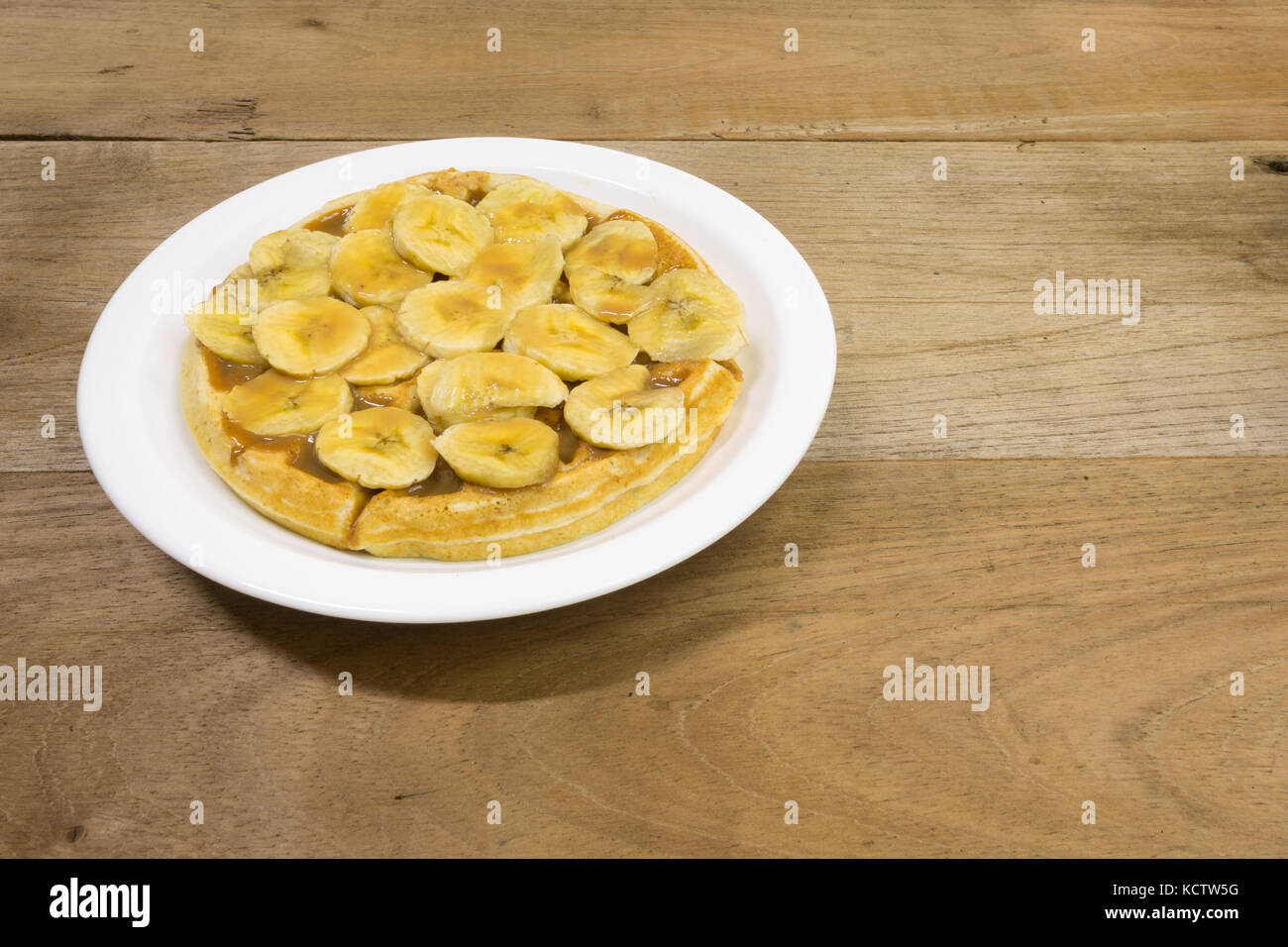 Waffle with milk caramel spread (Spanish Dulce de leche) and banana