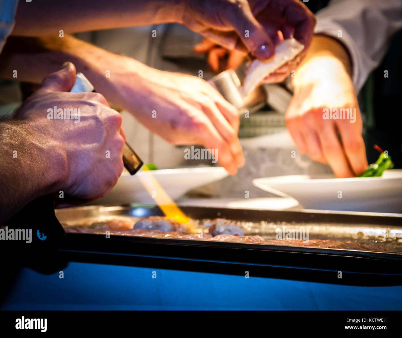 Chef in kitchen cooking with gas burner Stock Photo
