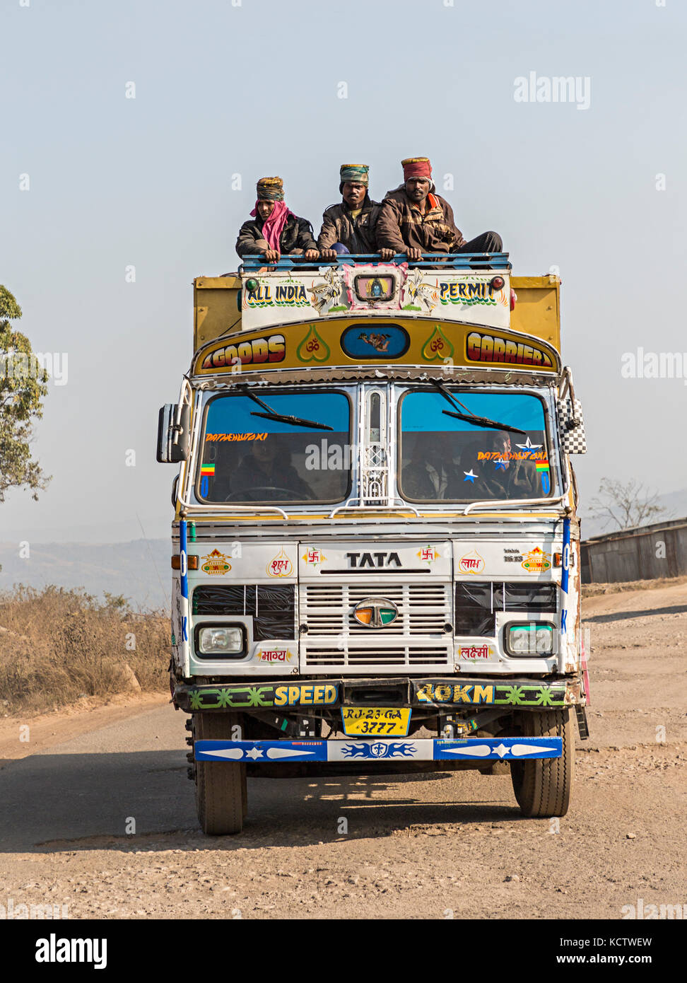 Brighly decorated lorry with people on top, Meghalaya, India Stock Photo