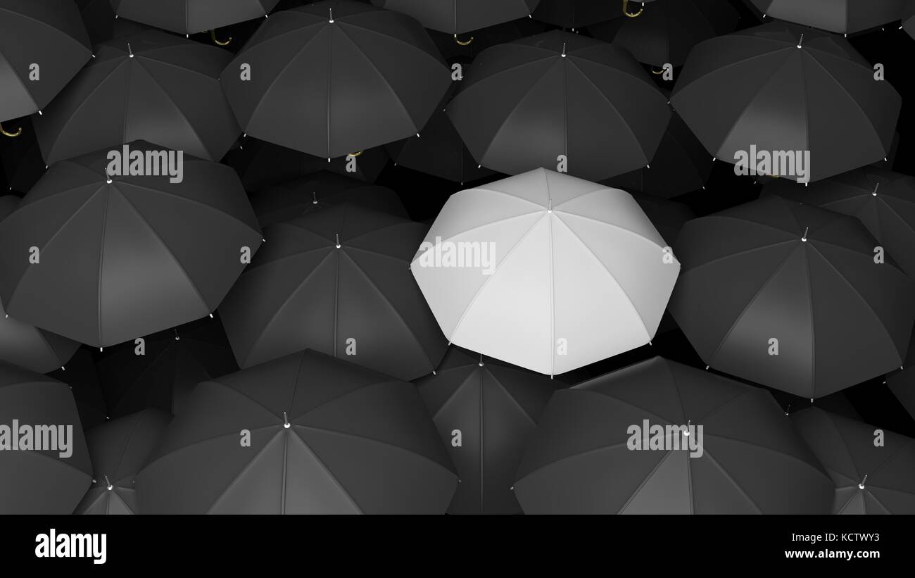Classic large black umbrellas tops with one white standing out Stock