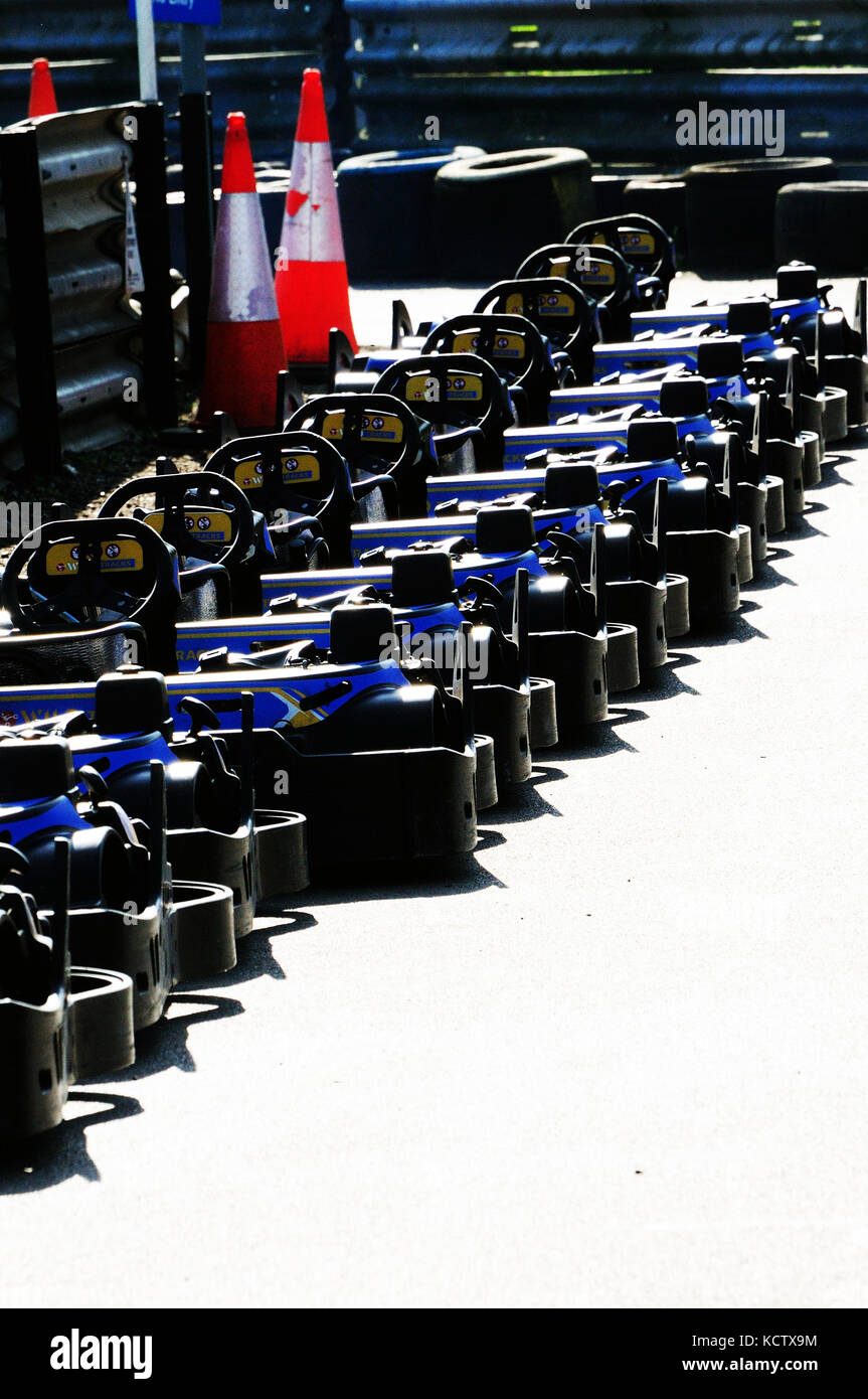 row of go karts for hire at the side of a karting track Stock Photo