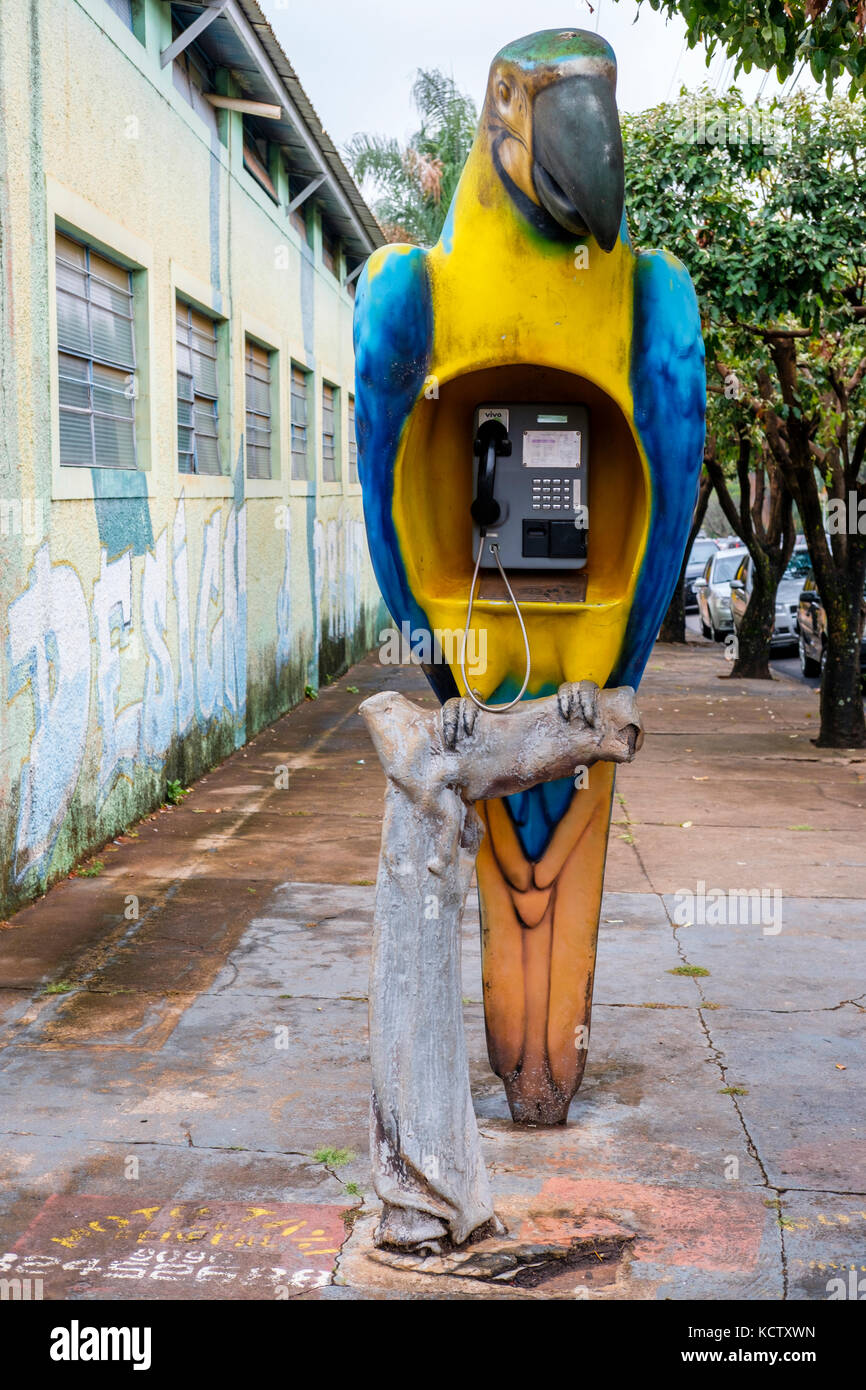 Vivo public telephone, payphone, shaped as a macaw on a sidewalk in Jose Bonifacio, state of Sao Paulo, Brazil. Stock Photo
