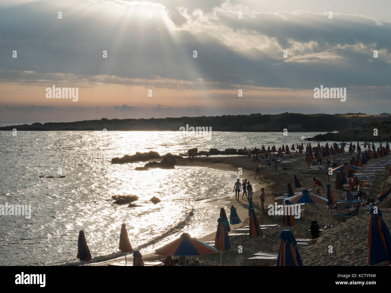 Sunrays burst through from behind the clouds at Coral Bay in the Peyia district, near Paphos, Cyprus. Stock Photo