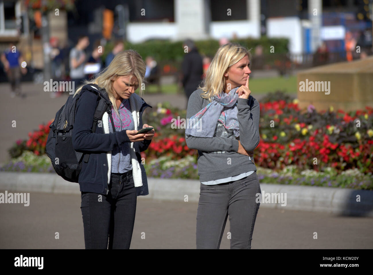 George square Glasgow  blonde Scandinavian  women female girl tourists map reading posing Stock Photo