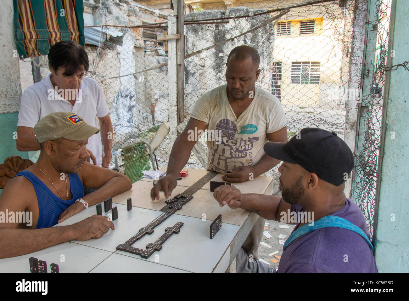 Playing dominoes outside in  Habana Vieja, Old Havana,  Cuba Stock Photo