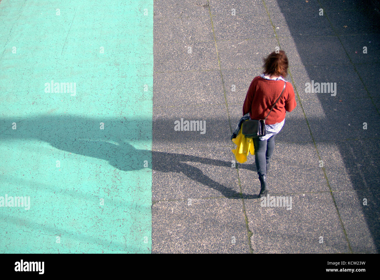colourful  casually dressed woman viewed from behind on clyde walkway glasgow Stock Photo