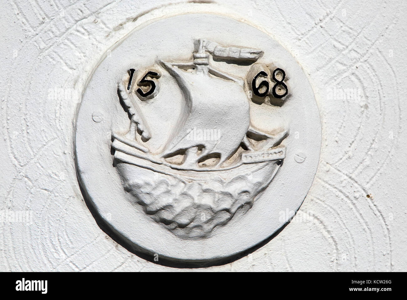 Historic ship pargeting plasterwork dated 1568 on wall in Quay Side, Woodbridge, Suffolk, England, UK Stock Photo