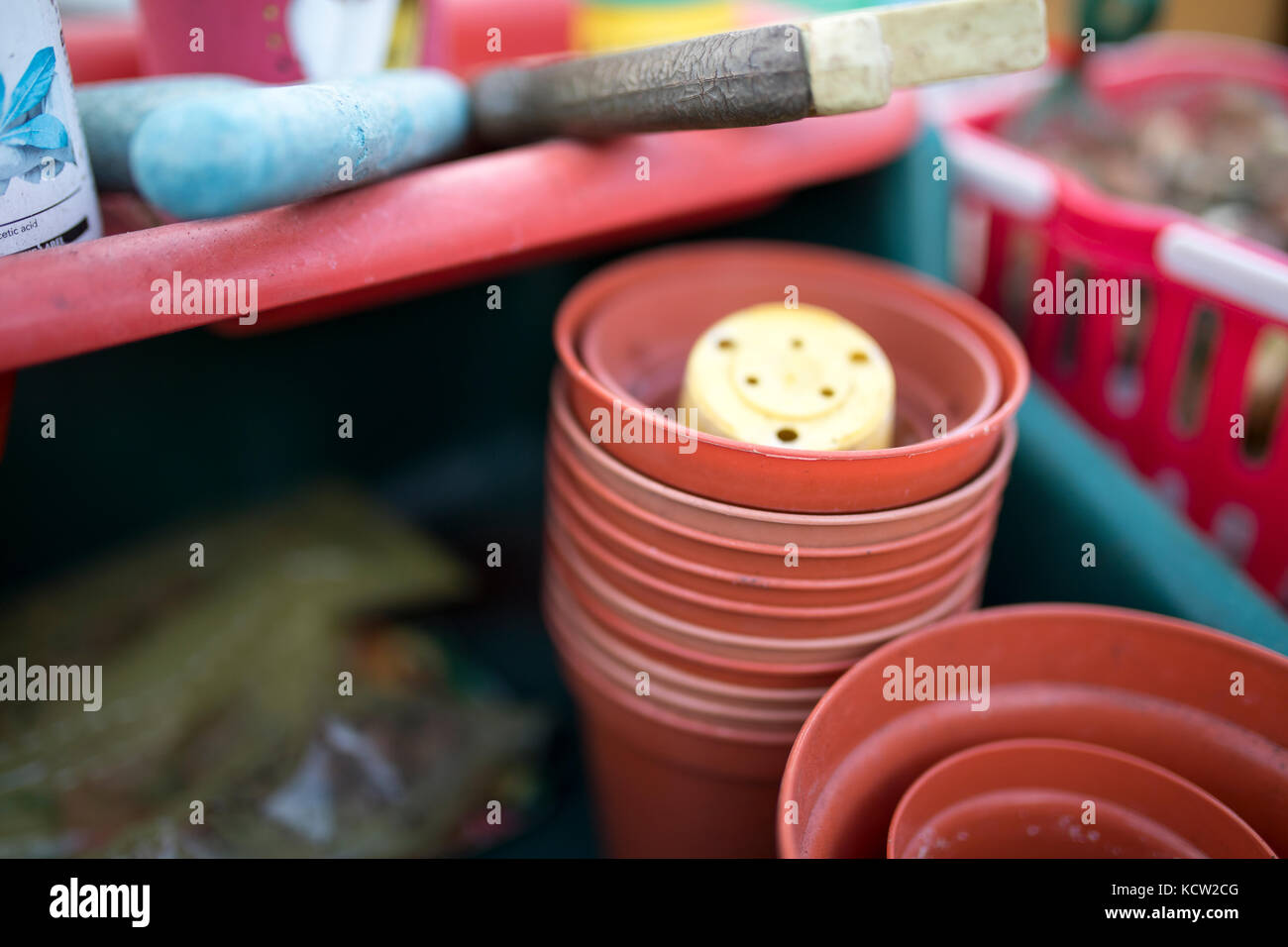 Close up of flower pots and tools in a green house or potting shed