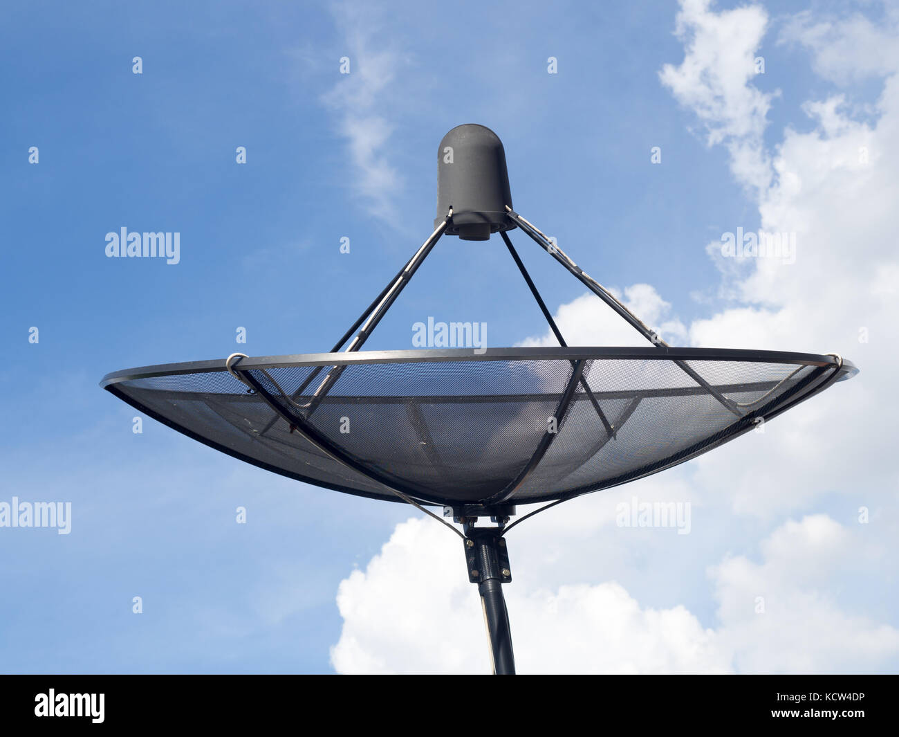 Black satellite dish or TV antennas install on the house roof on blue