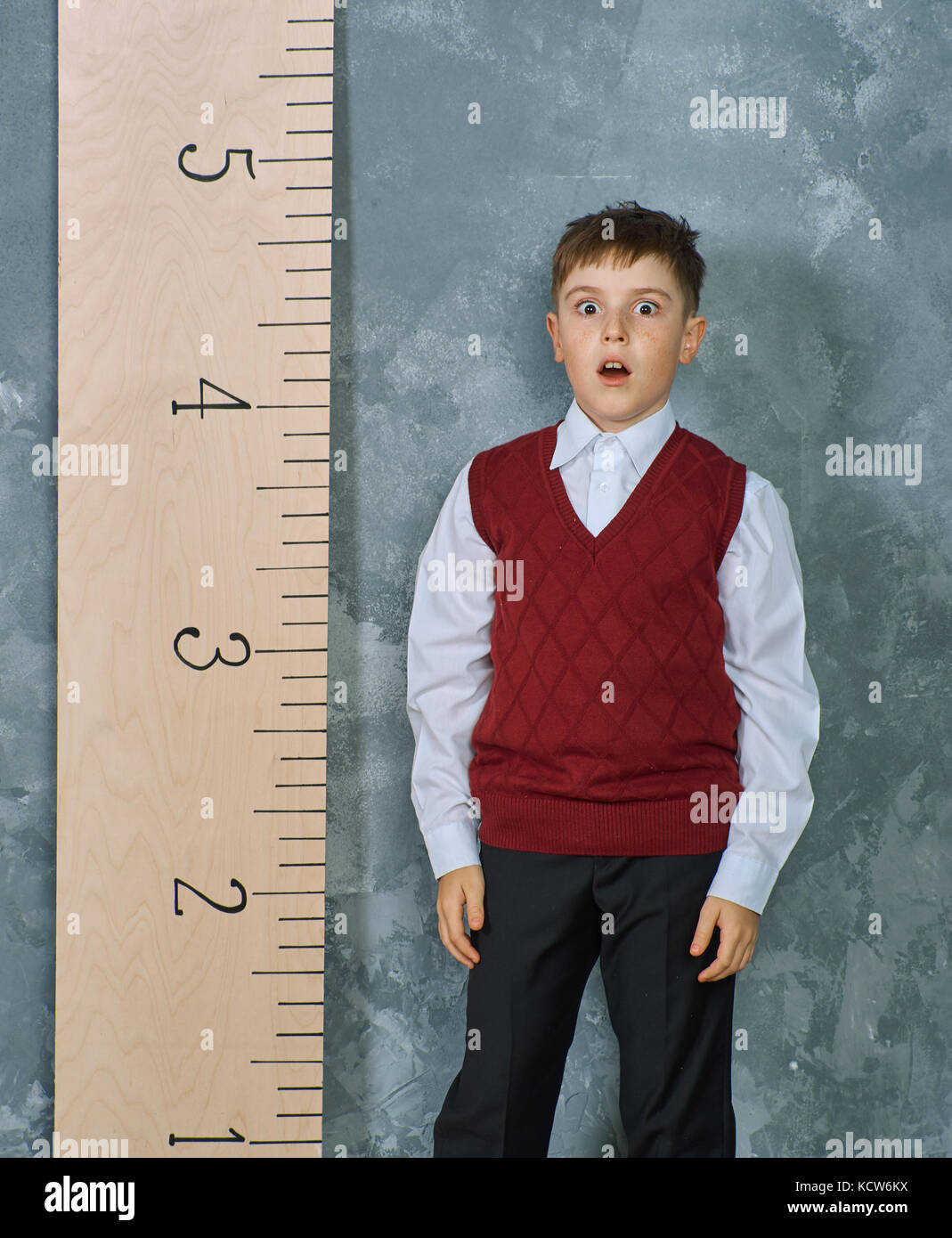 Schoolboy next to the measuring ruler, vintage concept Stock Photo - Alamy