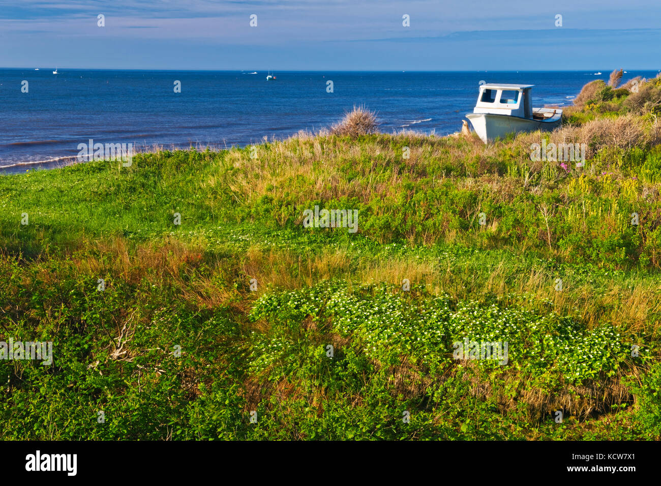 A landed boat on the coastline of Lamèque Island, New Brunswick, Canada Stock Photo