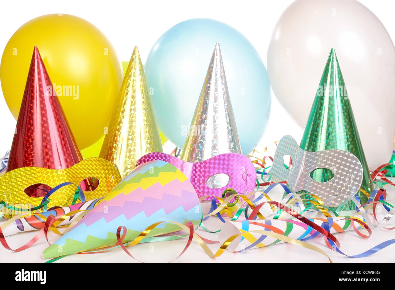 Party cone caps, streamers, pipes, balloons and carnival masks Stock Photo