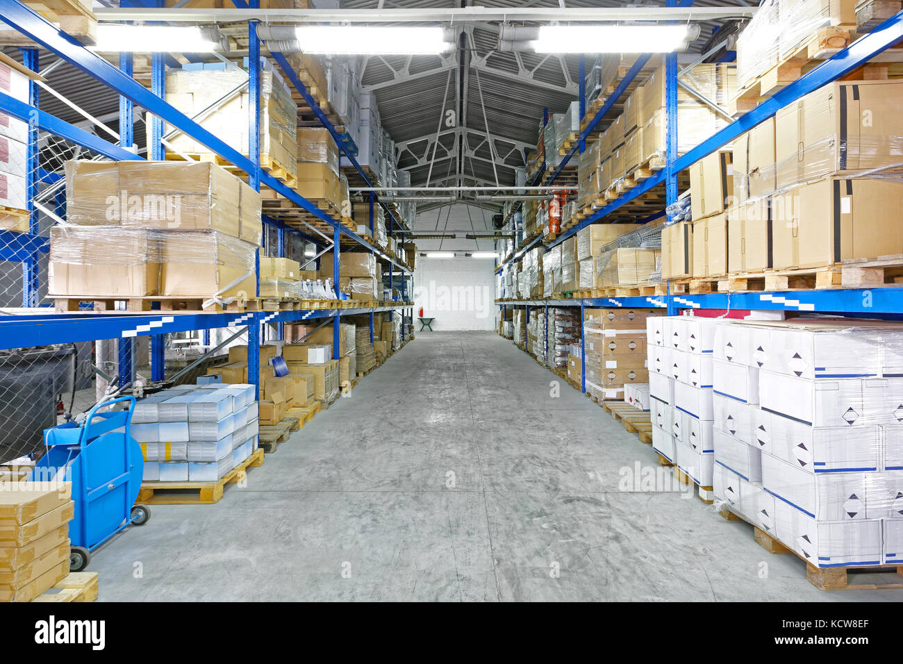 Row with Goods at Pallets in Distribution Warehouse Stock Photo