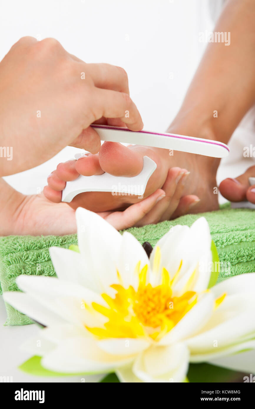 Close-up Of Manicurist Filing A Female Nails In A Beauty Salon Stock Photo