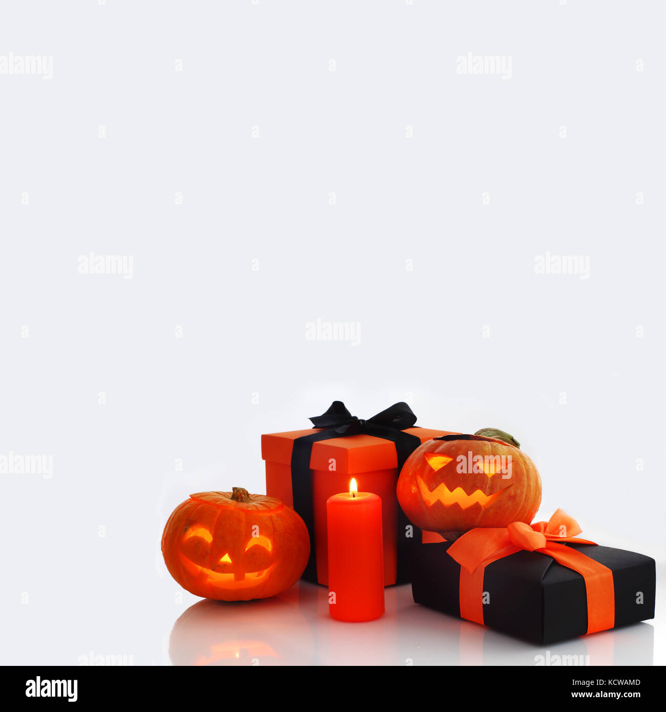 Halloween pumpkin and gifts on gray background Stock Photo