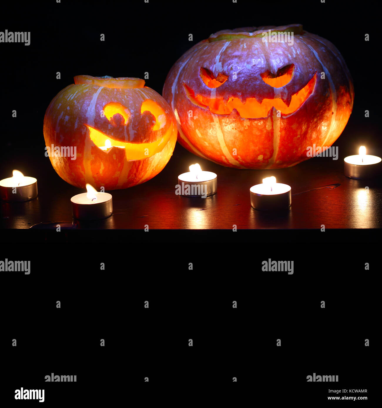 Illuminated cute halloween pumpkins isolated on black background Stock ...