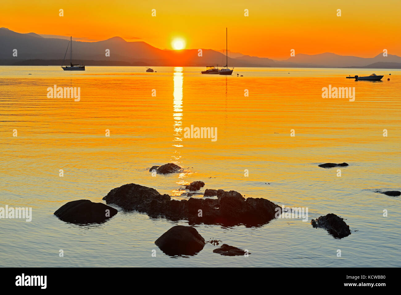 Sailboats at sunset on Vesuvius Bay. Looking West to Crofton on Vancouver Island. , Saltspring Island (Gulf Islands), British Columbia, Canada Stock Photo