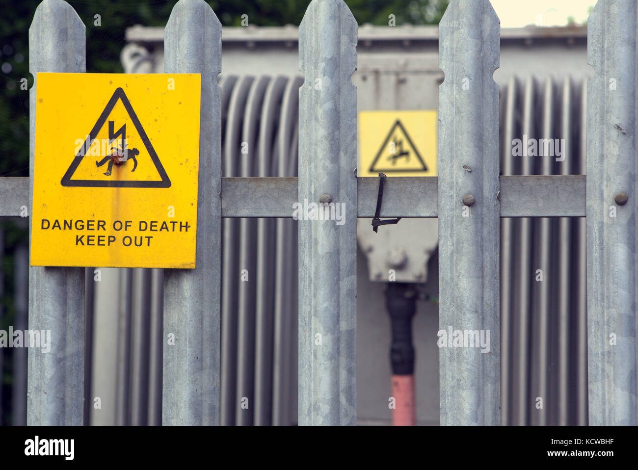 danger of death keep out electrical electricity yellow sign railings Fence Stock Photo