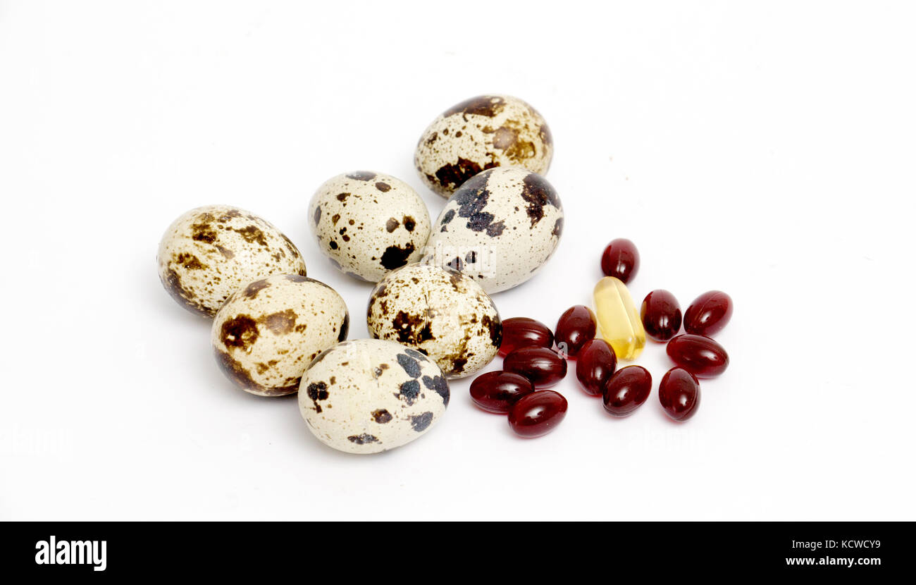 japanese quail eggs and omega 3 capsules ,food and health concept Stock