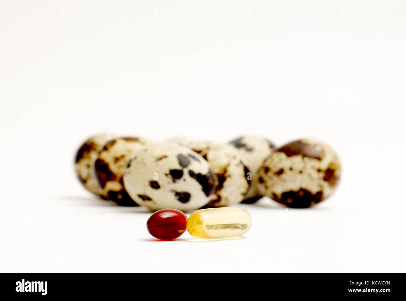 japanese quail eggs and omega 3 capsules ,food and health concept Stock