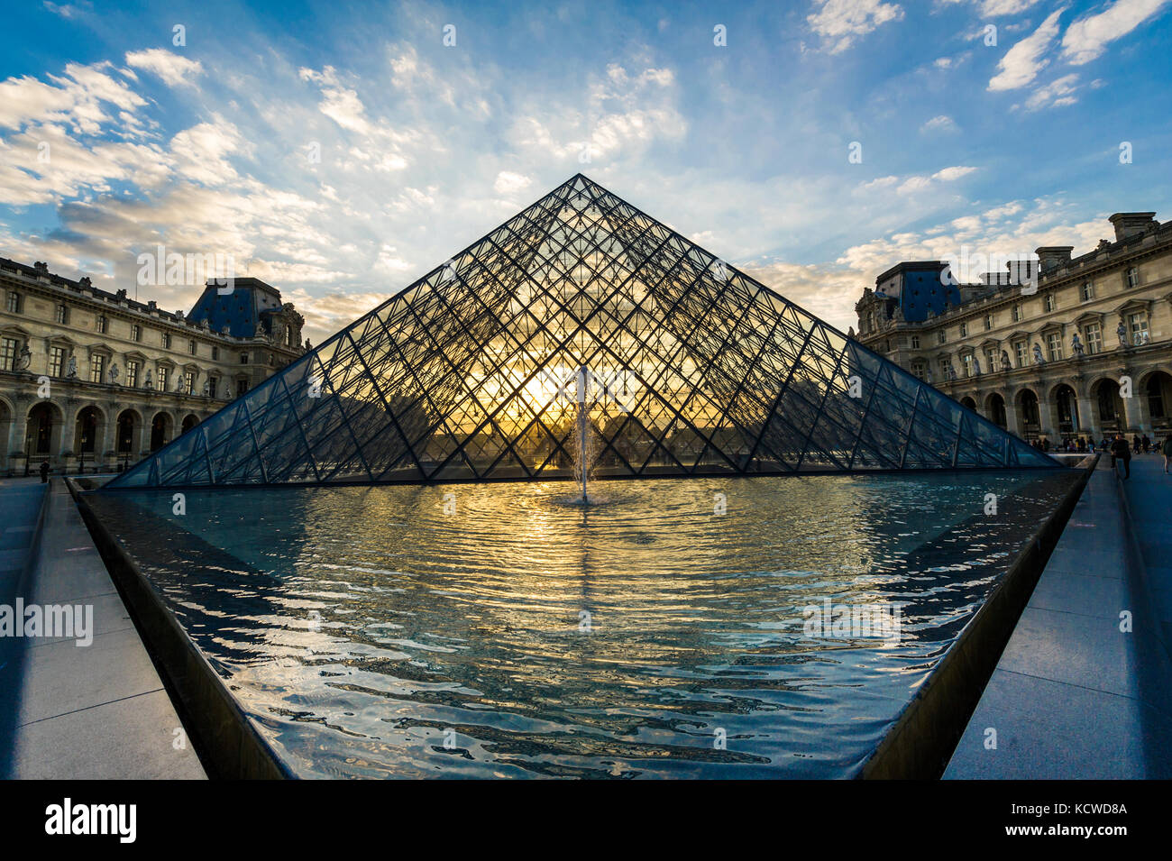 Louvre Pyramid at sunset Stock Photo