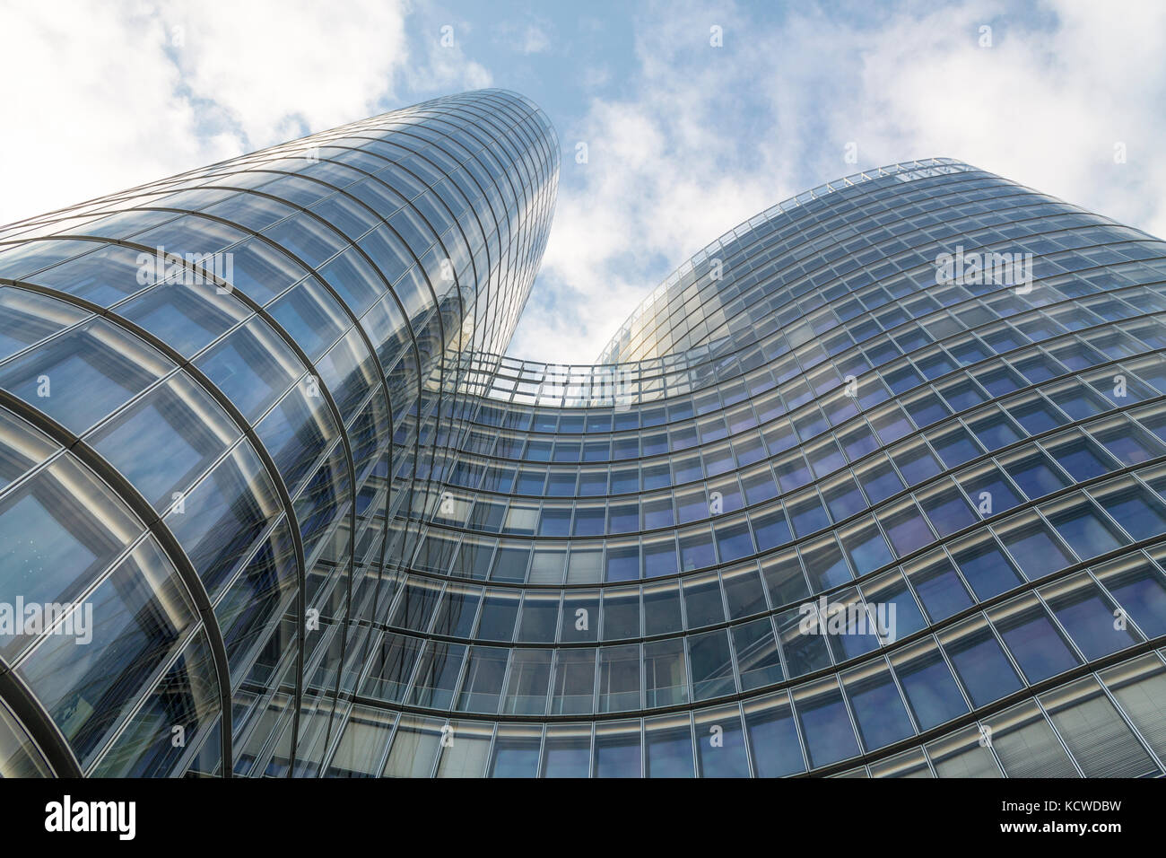 Glass modern building on a blue cloudy sky Stock Photo - Alamy