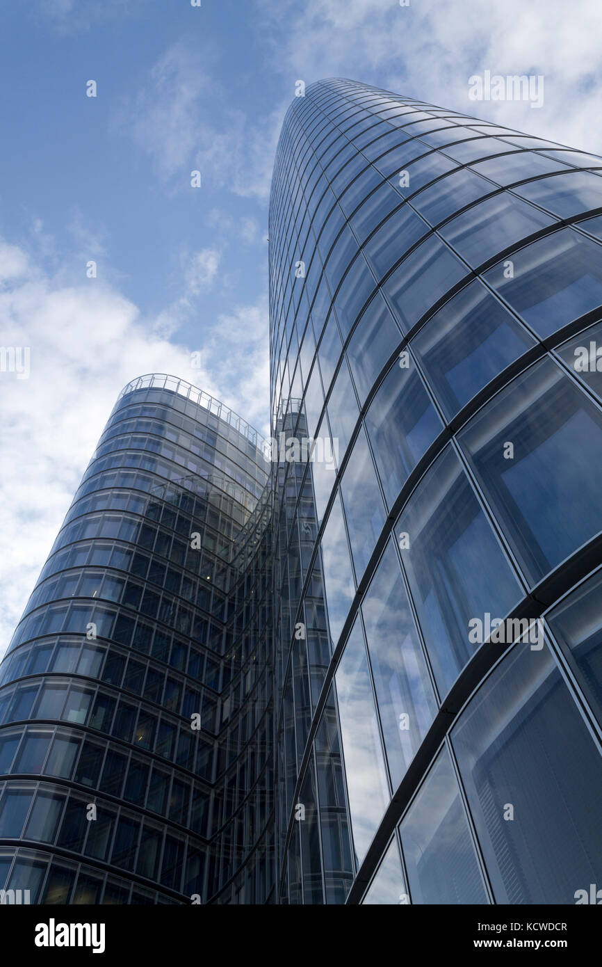 Glass modern building on a blue cloudy sky Stock Photo - Alamy