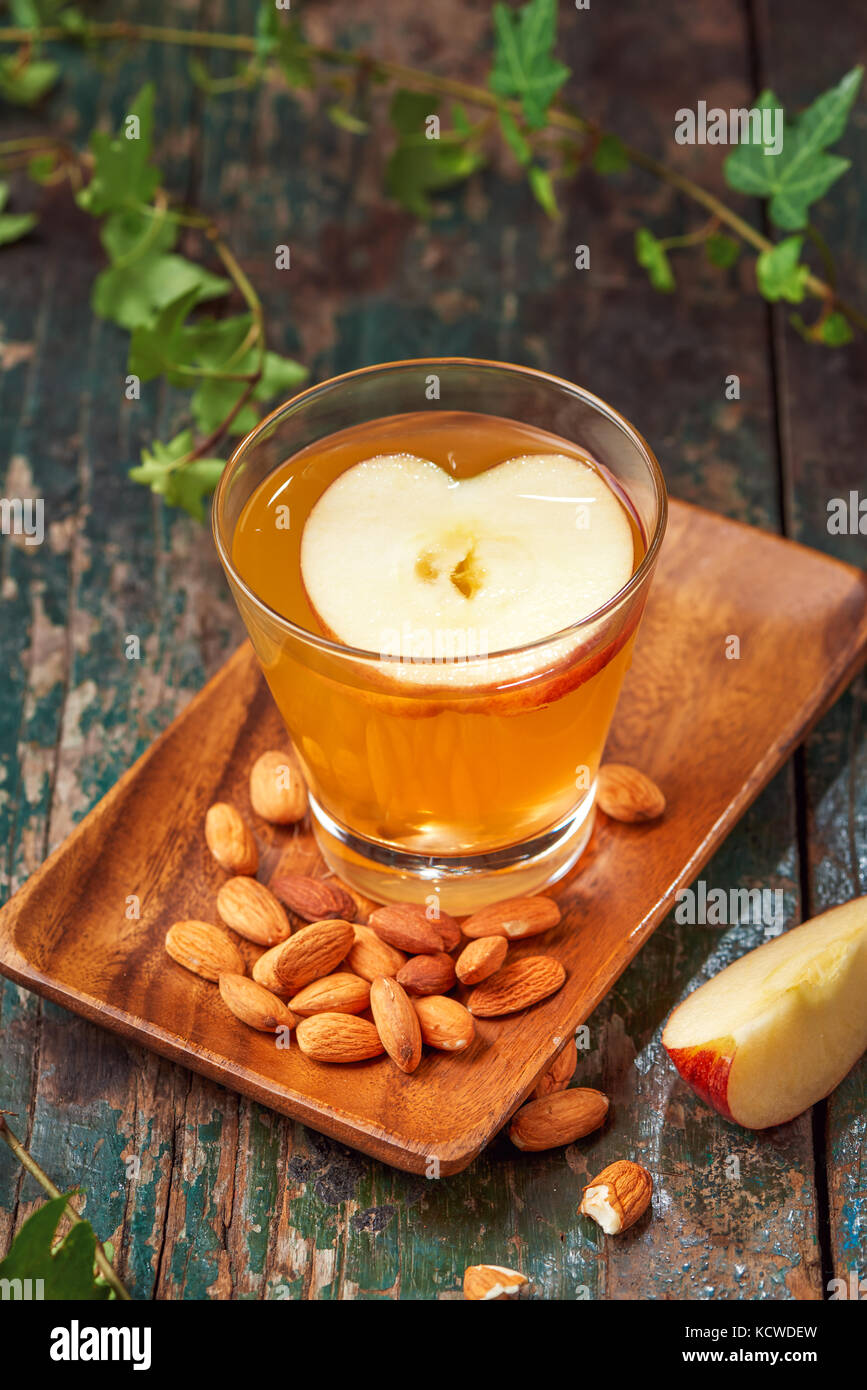 Hot drink of apple tea with cinnamon stick. Hot drink with apples for autumn or winter. Stock Photo
