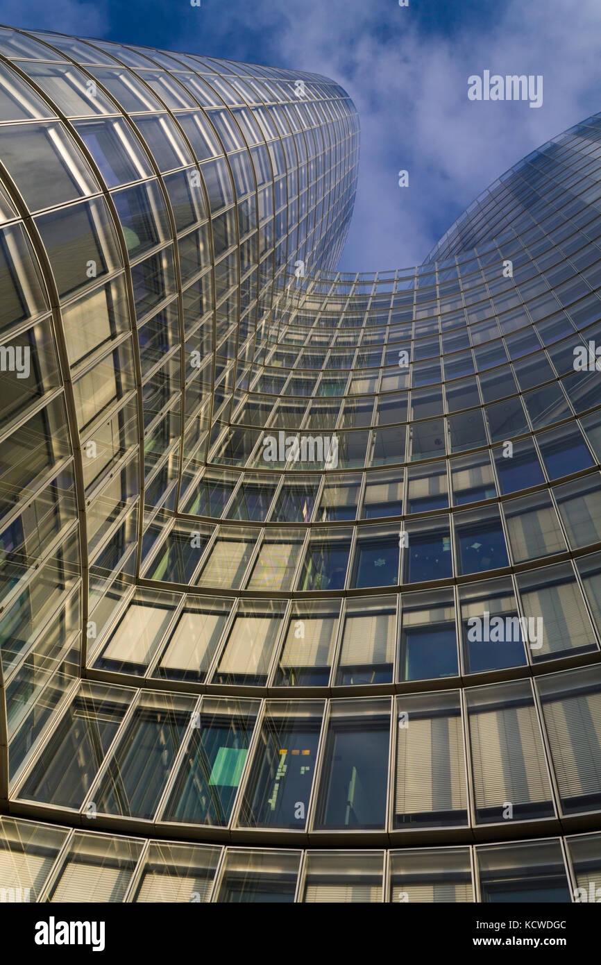 Glass modern building on a blue cloudy sky Stock Photo - Alamy