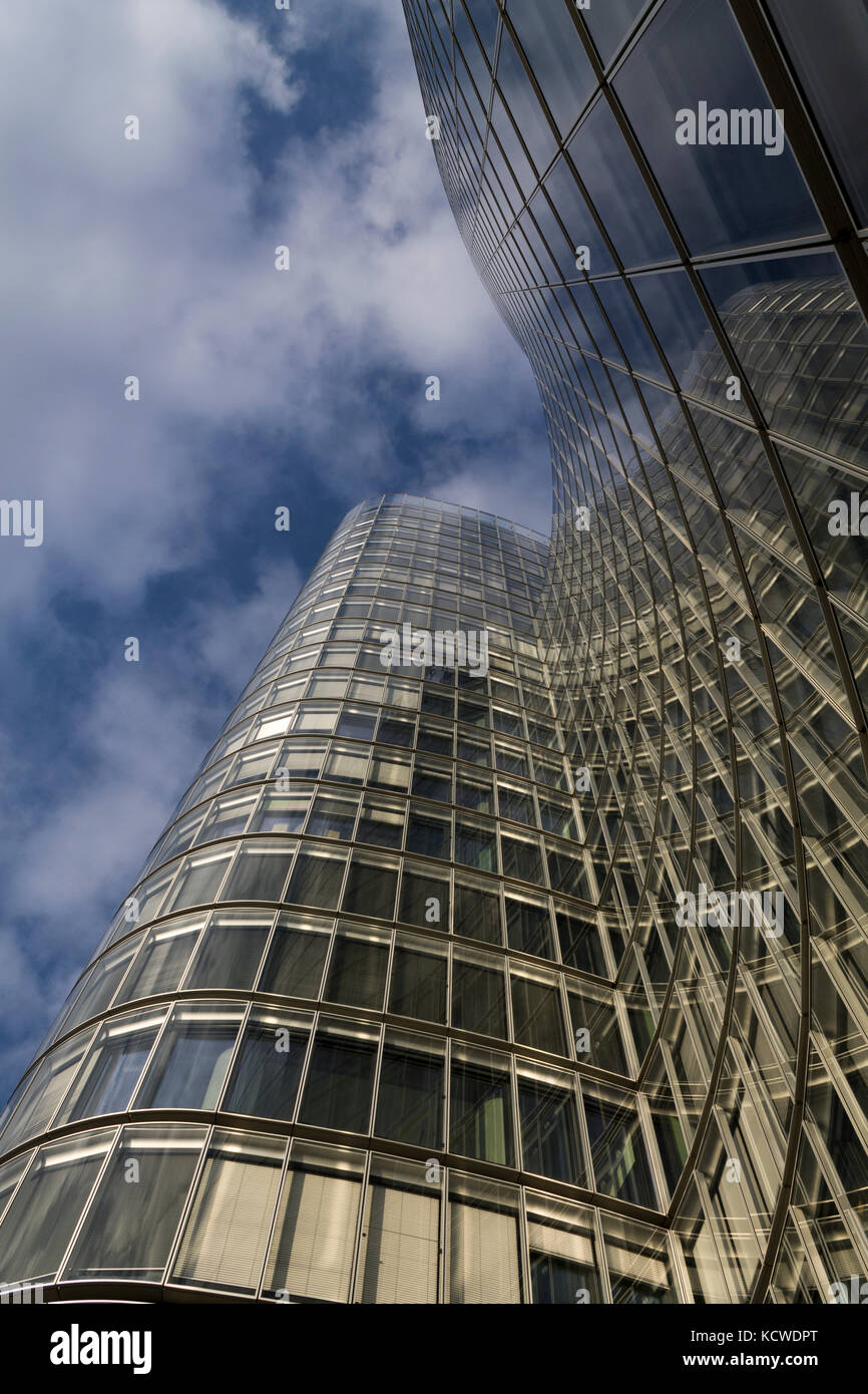 Glass modern building on a blue cloudy sky Stock Photo - Alamy