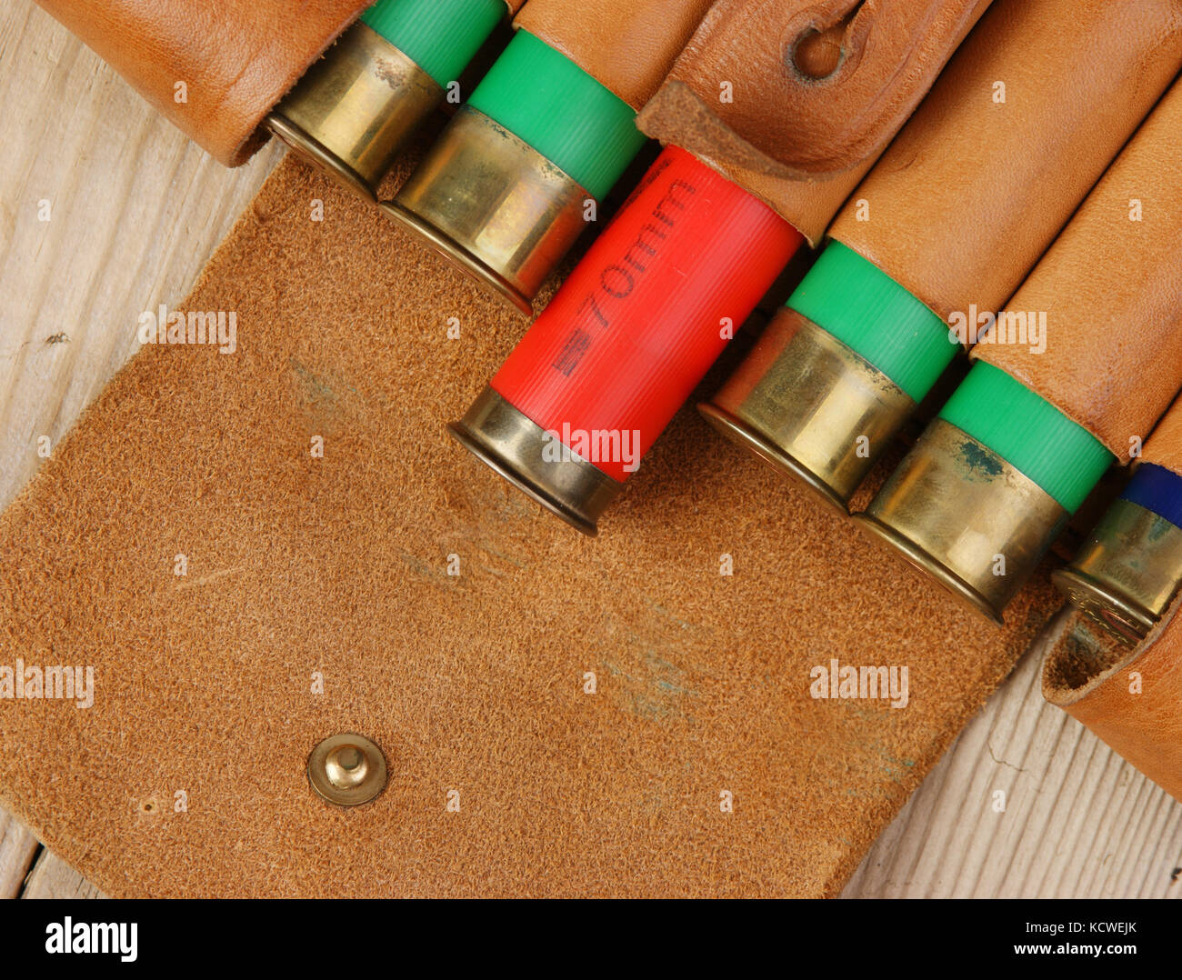 Old hunting cartridges and bandoleer on a wooden table Stock Photo
