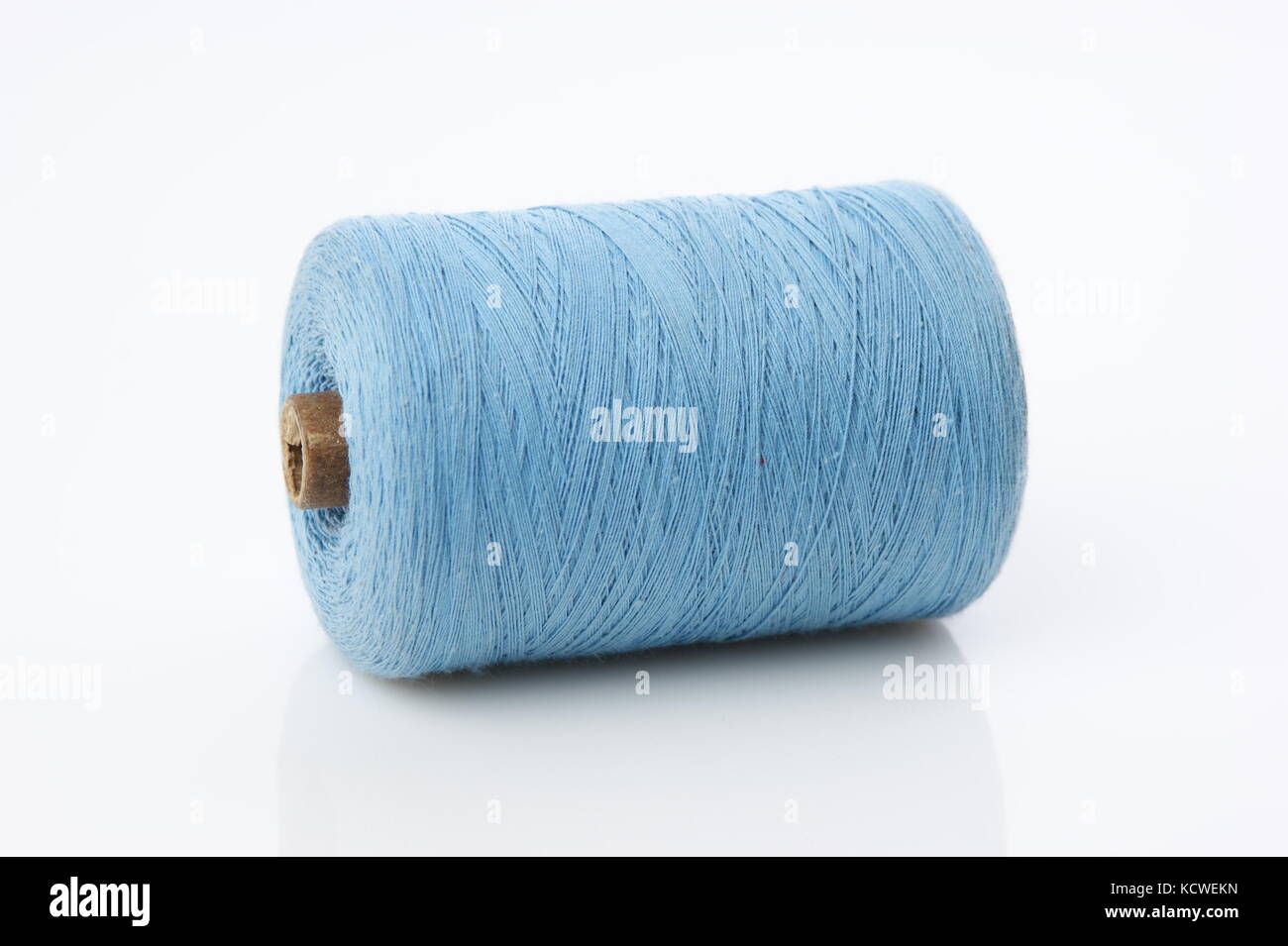 bobbin with blue thread on a white background Stock Photo - Alamy