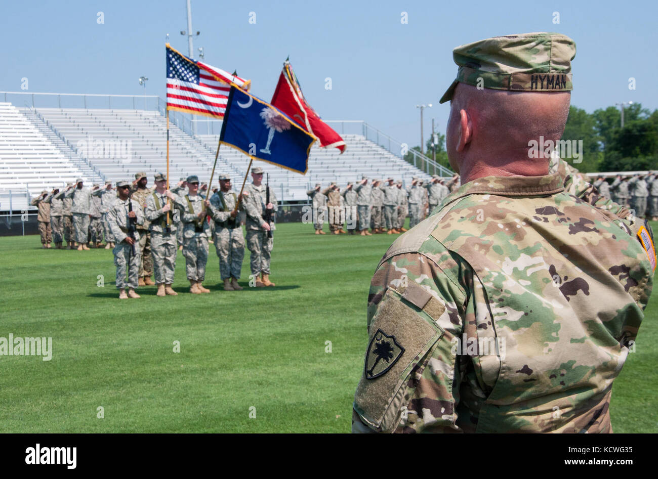 U.S. Army Lt. Col. Christopher Hyman salutes during the national anthem