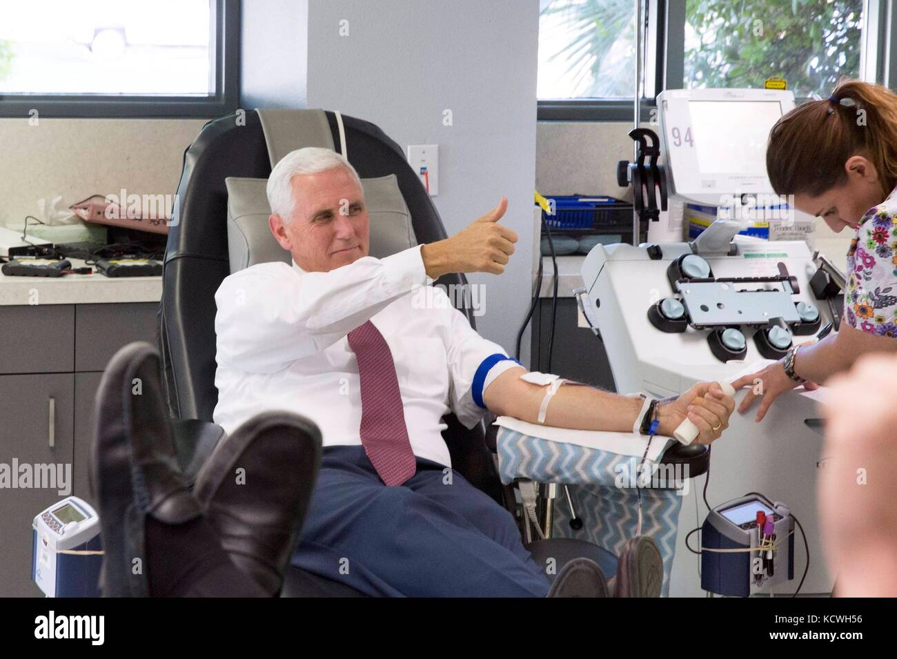 U.S. Vice President Mike Pence gives a thumbs up as he donates blood for the victims of the mass shooting in Las Vegas at the United Blood Services blood donation center October 4, 2017 in Phoenix, Arizona. Stock Photo