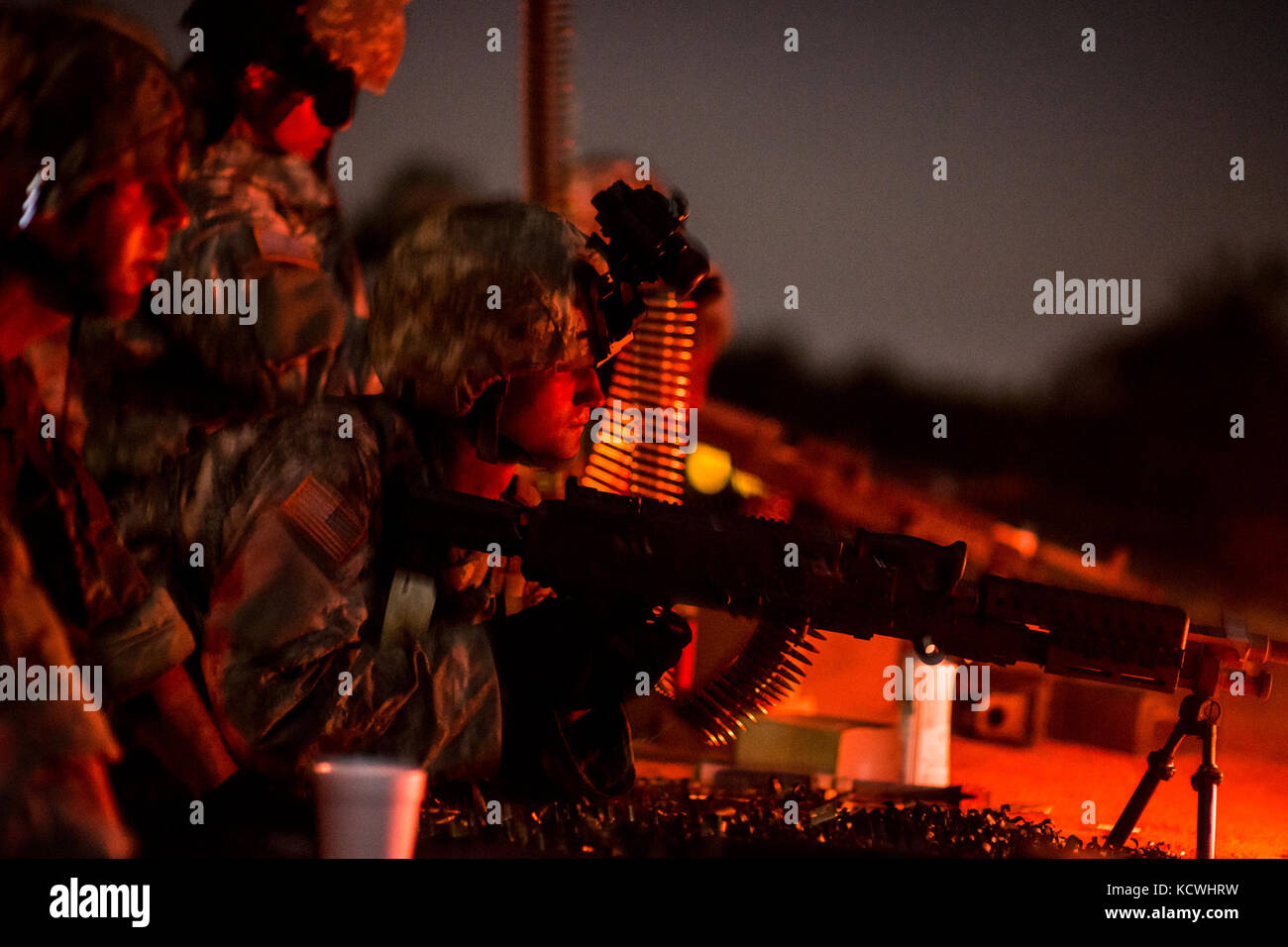 U.S. Army Spc. Edward Carr, combat engineer assigned to the 218th Maneuver Enhancement Brigade, S.C. Army National Guard fires a M240B machine gun during the crew-served weapons familiarization night training at Fort Jackson, S.C., Sept. 15, 2016.  Carr is assisting in the training of 30 Soldiers from multiple transportation and signal companies on dismounted security drills and crew-served weapons in preparation for their qualification next summer and to stay current with convoy security. (U.S. Air National Guard photo by Tech. Sgt. Jorge Intriago) Stock Photo