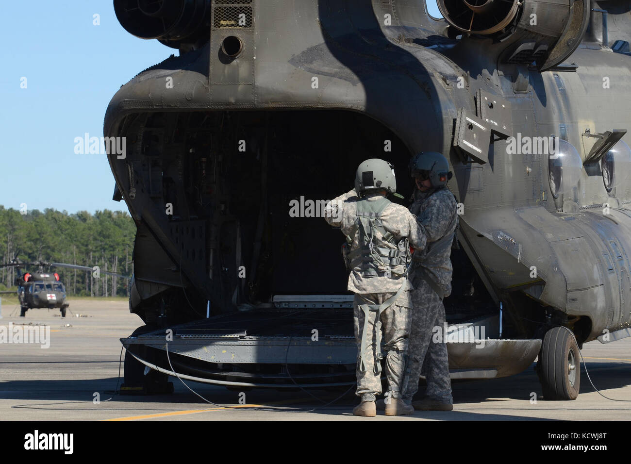 A South Carolina National Guardâs CH-47F Chinook, a heavy-lift helicopter configured with an Extended Range Fueling System (ERFS), also referred to as the &quot;Fat Cow,&quot; and its aircrew assigned to Detachment 1, Company B, 2-238th General Support Aviation Battalion, 59th Aviation Troop Command from Greenville S.C., stages its base of operations in support of Hurricane Matthew recovery efforts at McEntire Joint National Guard Base, Eastover, S.C., Oct. 10, 2016. Approximately 2,000 South Carolina National Guard Soldiers and Airmen were activated in direct support to Hurricane Matthew resp Stock Photo