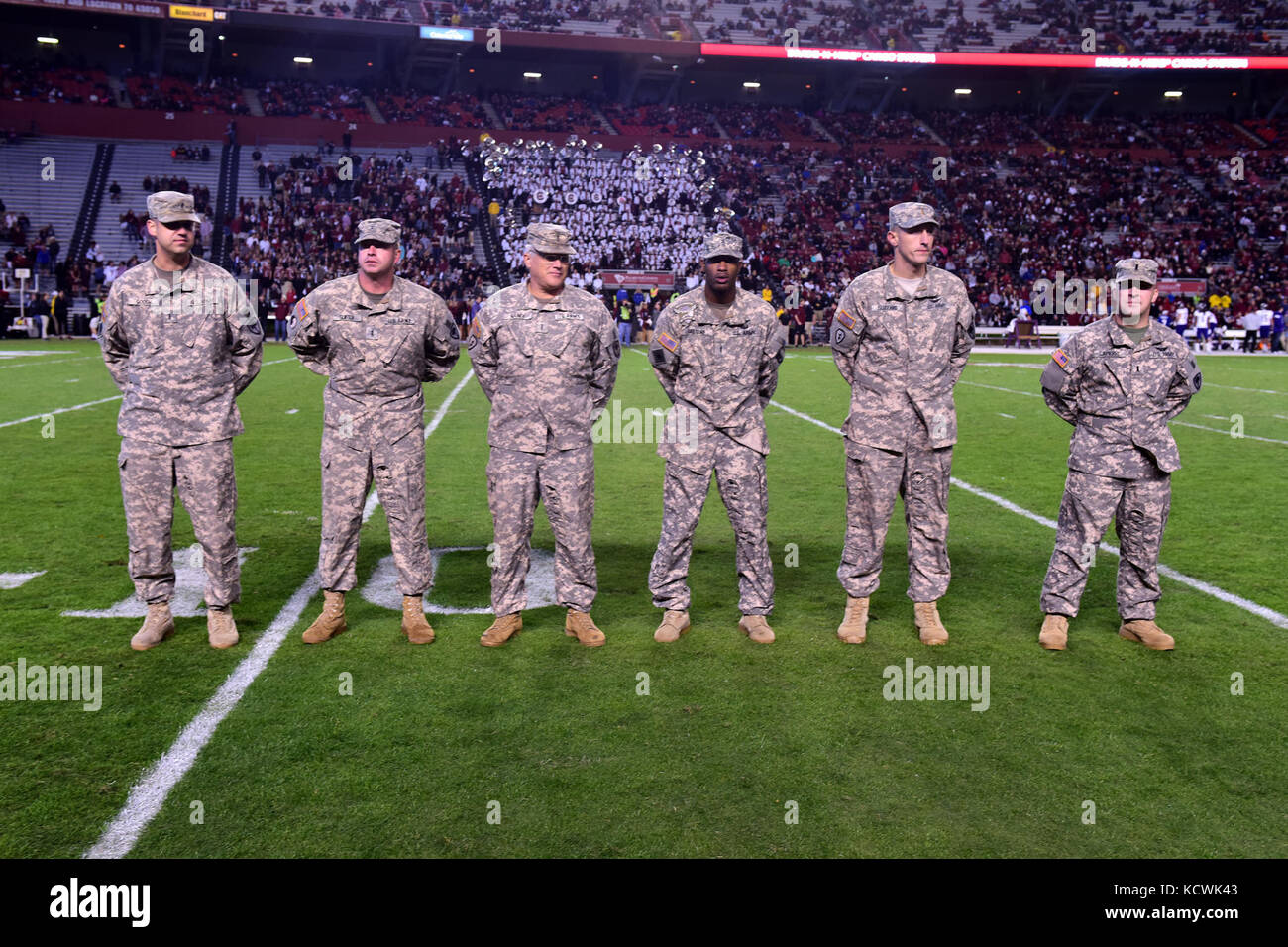 South Carolina Army National Guard AH-64 Apache helicopter pilots with the 1-151st Attack Reconnaissance Battalion at McEntire Joint National Guard Base, are recognized after a fly-over at Williams-Brice stadium in Columbia, South Carolina, Nov. 19, 2016. The South Carolina Army National Guard fly-over was in support of Fort Jackson's participation in the University of South Carolina's military appreciation game. (U.S. Air National Guard photo by Airman 1st Class Megan Floyd) Stock Photo