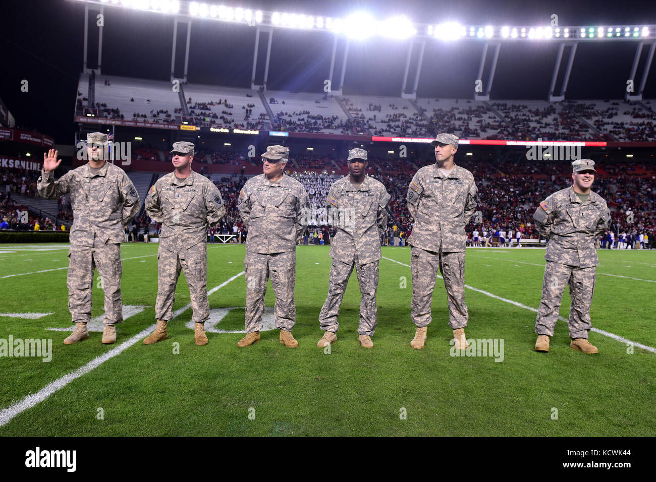 U.S. Army Chief Warrant Officer 3 Joel Gooch, South Carolina National Guard, 1-151st Attack Reconnaissance Battalion UH-64 Apache pilot, receives recognition at Williams-Brice stadium in Columbia, South Carolina, Nov. 19, 2016. The South Carolina Army National Guard conducted a fly-over in support of Fort Jackson's participation in the University of South Carolina's military appreciation game. (U.S. Air National Guard photo by Airman 1st Class Megan Floyd) Stock Photo