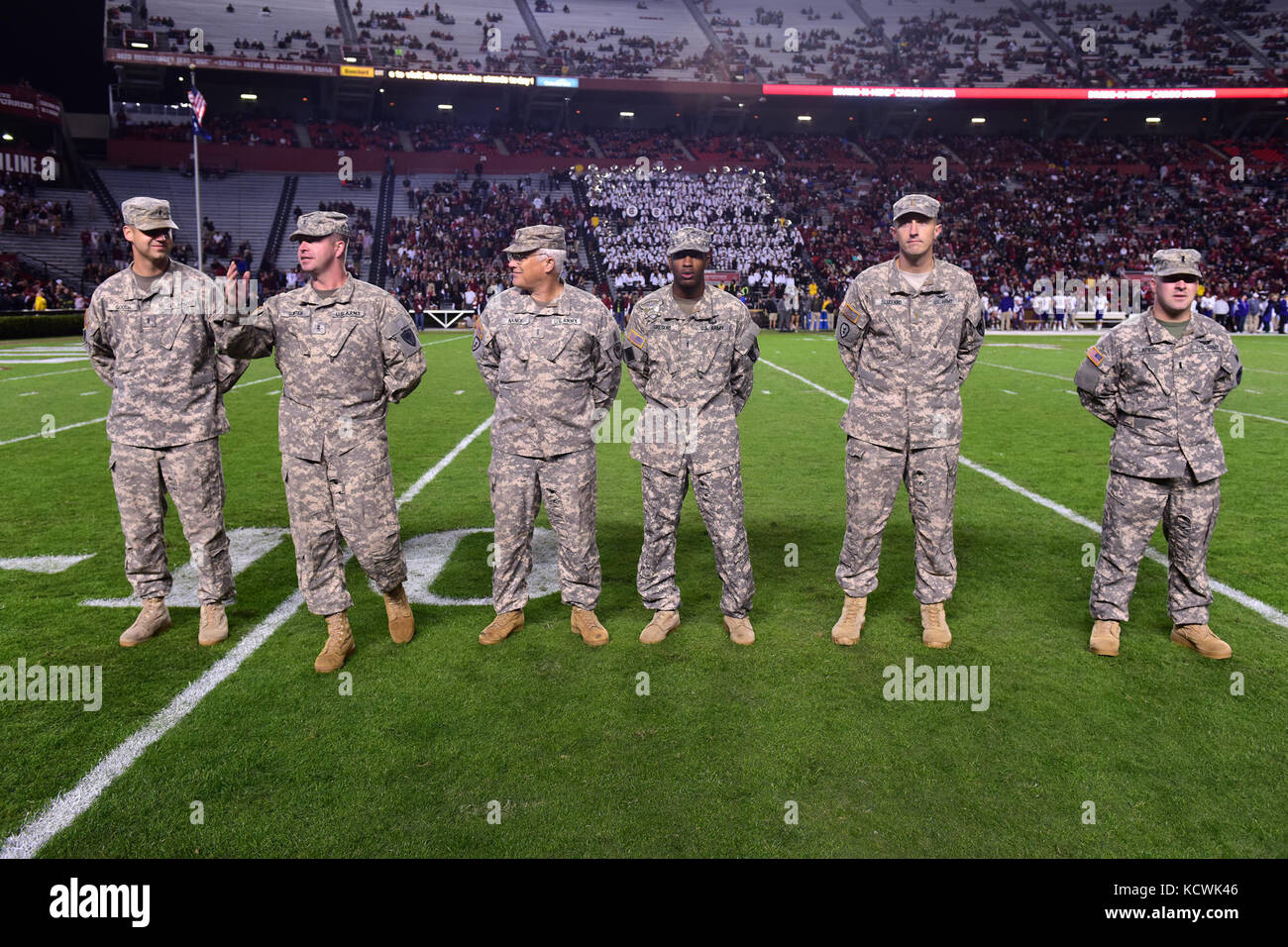 U.S. Army Chief Warrant Officer 2 Larry Gunter, South Carolina National Guard, 1-151st Attack Reconnaissance Battalion UH-64 Apache pilot, receives recognition at Williams-Brice stadium in Columbia, South Carolina, Nov. 19, 2016. The South Carolina Army National Guard conducted a fly-over in support of Fort Jackson's participation in the University of South Carolina's military appreciation game. (U.S. Air National Guard photo by Airman 1st Class Megan Floyd) Stock Photo