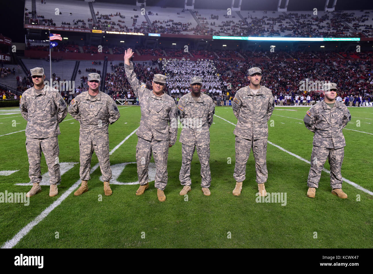 U.S. Army Chief Warrant Officer 5 Russell Nance, South Carolina National Guard, 1-151st Attack Reconnaissance Battalion UH-64 Apache pilot, receives recognition at Williams-Brice stadium in Columbia, South Carolina, Nov. 19, 2016. The South Carolina Army National Guard conducted a fly-over in support of Fort Jackson's participation in the University of South Carolina's military appreciation game. (U.S. Air National Guard photo by Airman 1st Class Megan Floyd) Stock Photo