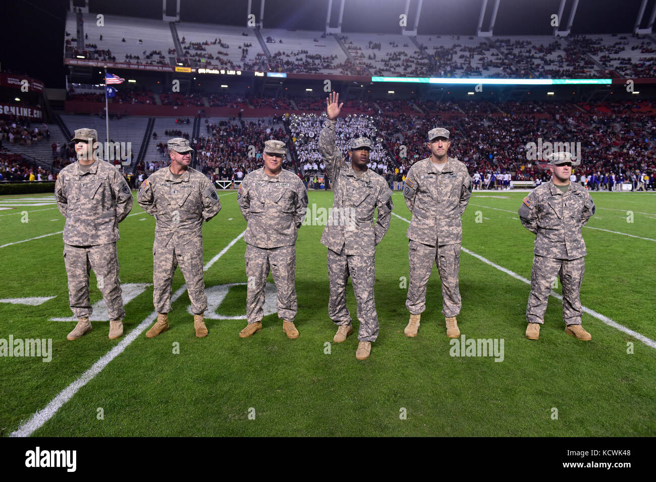 U.S. Army Chief Warrant Officer 2 Guion Gregory, South Carolina National Guard, 1-151st Attack Reconnaissance Battalion UH-64 Apache pilot, receives a game ball at Williams-Brice stadium in Columbia, South Carolina, Nov. 19, 2016. The South Carolina Army National Guard conducted a fly-over in support of Fort Jackson's participation in the University of South Carolina's military appreciation game. (U.S. Air National Guard photo by Airman 1st Class Megan Floyd) Stock Photo