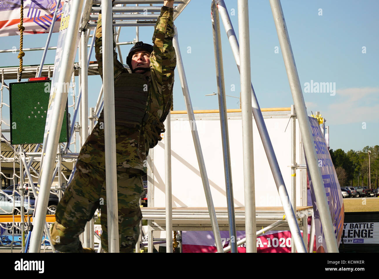 U.S. Army Warrant Officer Candidate Michael Atkinson, South Carolina Army National Guard, competes in the “Battle Challenge” mobile obstacle course at McCrady Training Center in Eastover, South Carolina, Jan. 27, 2017. The Battle Challenge requires participants to perform nine tasks under pressure of time, including a cargo net climb, a knotted rope descent, wall surmount, ammunition resupply, low crawl, gas can carry, marksmanship tasks, and a service member-down rescue. (U.S. Army National Guard photo by Capt. Brian Hare) Stock Photo