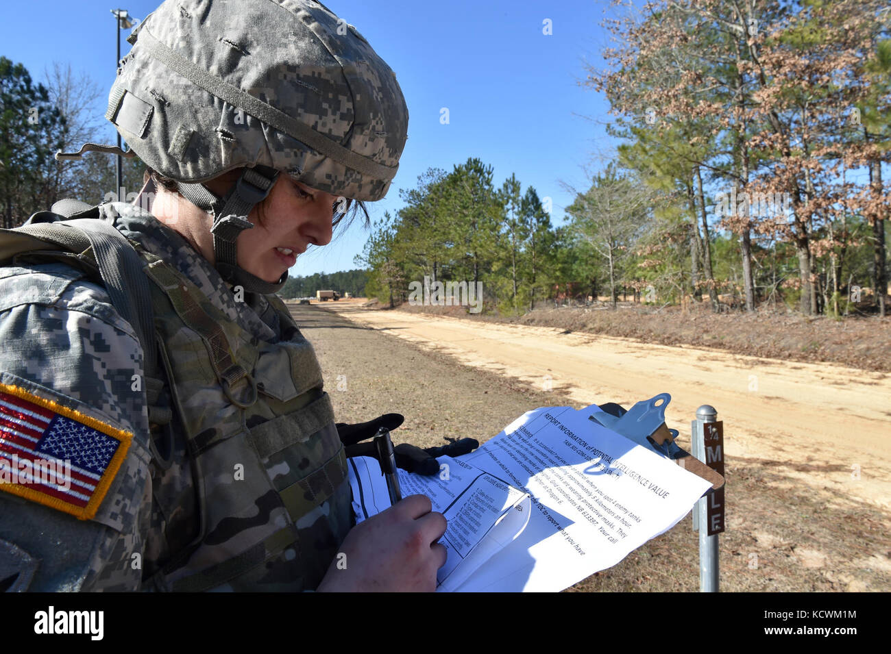 South Carolina Army National Guard Sgt. Rachel Clark, human resources non-commissioned officer with the 218th Leadership Regiment, completes a mystery challenge during the 2017 Best Warrior Competition at McCrady Training Center in Eastover, S.C., Jan 31, 2017. The Battle Challenge is a mobile obstacle course requiring participants to perform nine tasks under pressure of time, including a cargo net climb, a knotted rope descent, wall surmount, ammunition resupply, low crawl, gas can carry, marksmanship tasks, and a service member-down rescue. The event was open to all military service members, Stock Photo